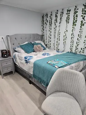 a bedroom with a bed and a chair at House in New Jersey in Paterson