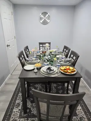 a dining room table with plates of food on it at House in New Jersey in Paterson
