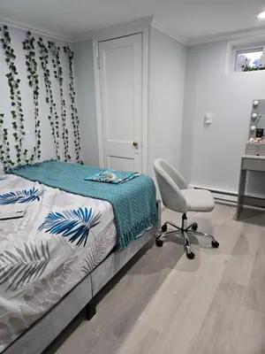 a bedroom with a bed and a chair at House in New Jersey in Paterson