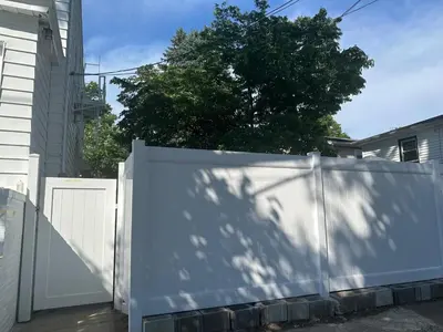 a white fence in front of a house with a tree at Divine Villa Guest House Harper Ave WITH FREE PRIVATE PARKING in Irvington
