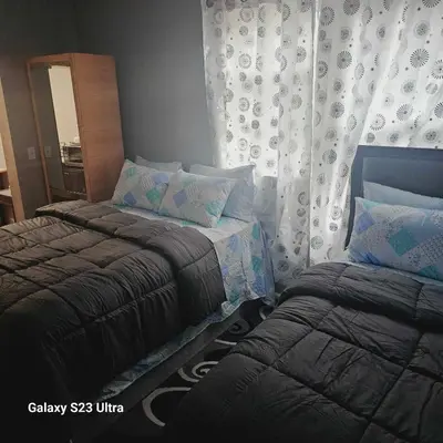 a bedroom with two beds and a mirror at Divine Villa Guest House Harper Ave WITH FREE PRIVATE PARKING in Irvington