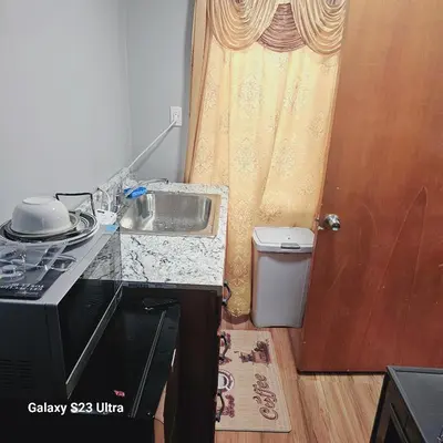 a kitchen with a sink next to a door at Divine Villa Guest House Harper Ave WITH FREE PRIVATE PARKING in Irvington