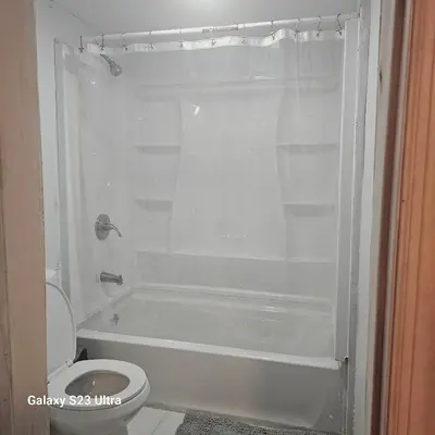 a bathroom with a white tub and a toilet at Divine Villa Guest House Harper Ave WITH FREE PRIVATE PARKING in Irvington