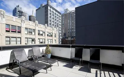 a group of chairs sitting on top of a balcony at Luxury Full Floor Chelsea with WasherDryer 2bd in New York