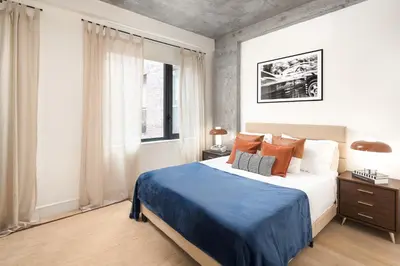 a bedroom with a large bed and a window at Luxury Full Floor Chelsea with WasherDryer 2bd in New York