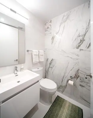 a white bathroom with a sink and a toilet at Luxury Full Floor Chelsea with WasherDryer 2bd in New York