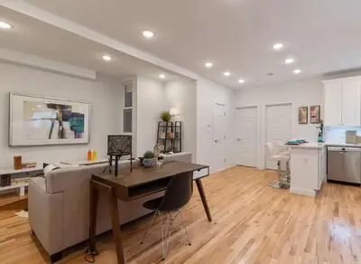 a living room with a table and a couch at Modern & Spacious 3 BED & 2 BA Condo mins from NYC in Jersey City