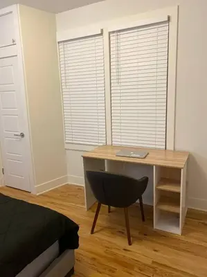 a desk with a laptop and a chair in a room at Modern & Spacious 3 BED & 2 BA Condo mins from NYC in Jersey City