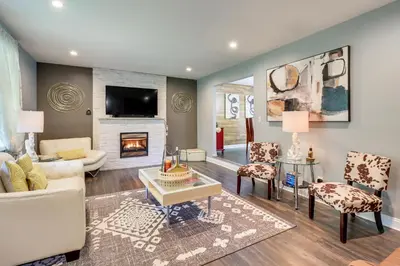 a living room with a couch and a fireplace at Long Pond Home with Hot Tub about 8 Mi to Kalahari! in Long Pond