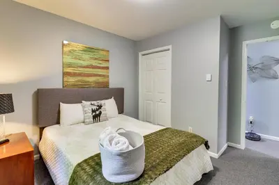 a bedroom with a bed and a painting on the wall at Long Pond Home with Hot Tub about 8 Mi to Kalahari! in Long Pond