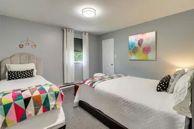 a bedroom with two beds and a window at Long Pond Home with Hot Tub about 8 Mi to Kalahari! in Long Pond