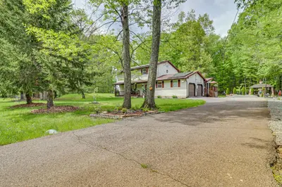a driveway leading to a house with trees at Long Pond Home with Hot Tub about 8 Mi to Kalahari! in Long Pond