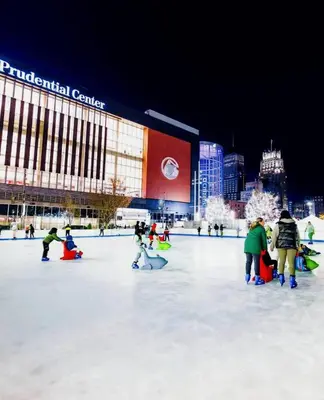 a group of people on an ice rink in front of a building at Harmony in the Heights - Master in Newark