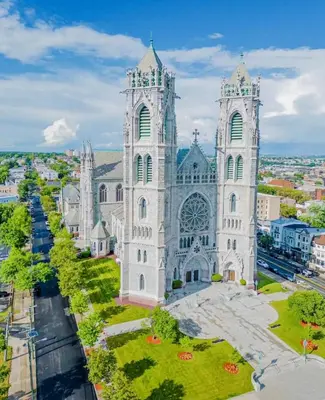a large cathedral with two towers on a city street at Harmony in the Heights - Master in Newark