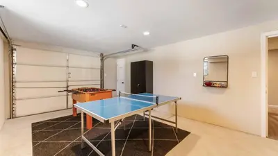 a ping pong table in the middle of a room at Birchwood by AvantStay Game Room Lake Access in Blakeslee