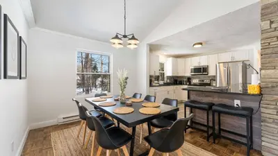 a kitchen and dining room with a table and chairs at Birchwood by AvantStay Game Room Lake Access in Blakeslee