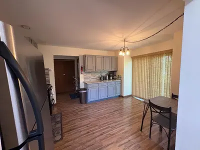 a living room with a kitchen and a dining room table at Ash Cottage in Poconos near Camelback & Kalahari in Long Pond