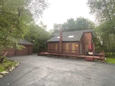 a large house with a driveway in front of it at Ash Cottage in Poconos near Camelback & Kalahari in Long Pond