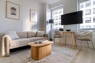 a living room with a couch and a table at Midtown West 1br w gym wd nr bryant park NYC-1380 in New York