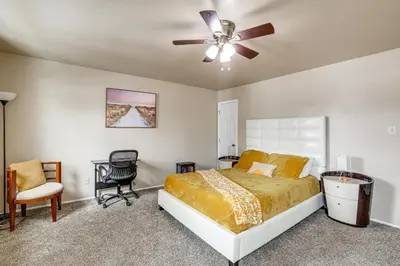 a bedroom with a bed and a ceiling fan at Walk to Mall and Train Station! Philly Suburb Stay in Willow Grove