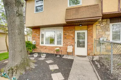 a house with a tree in front of it at Walk to Mall and Train Station! Philly Suburb Stay in Willow Grove