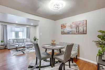 a living room with a table and chairs and a couch at Walk to Mall and Train Station! Philly Suburb Stay in Willow Grove