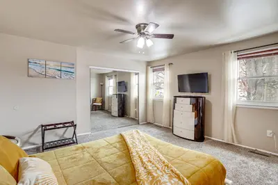 a living room with a couch and a ceiling fan at Walk to Mall and Train Station! Philly Suburb Stay in Willow Grove