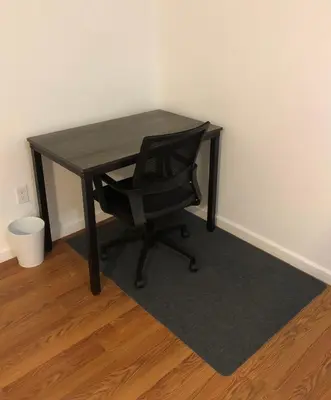 a black desk with a black chair in a room at Large apartment, sleeps up to 8 people comfortably, direct NYC Manhattan train only 5 minute walk away, MetLife Stadium FIFA World Cup 25 minutes away in Elizabeth