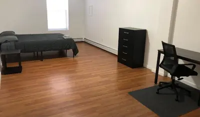 a bedroom with a bed and a desk and a chair at Large apartment, sleeps up to 8 people comfortably, direct NYC Manhattan train only 5 minute walk away, MetLife Stadium FIFA World Cup 25 minutes away in Elizabeth
