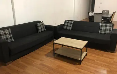 a living room with two black couches and a coffee table at Large apartment, sleeps up to 8 people comfortably, direct NYC Manhattan train only 5 minute walk away, MetLife Stadium FIFA World Cup 25 minutes away in Elizabeth