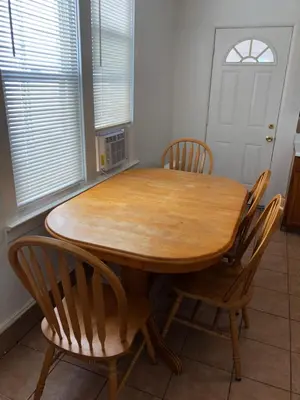 a wooden table and chairs in a kitchen at Private 2 bedroom and 1 bathroom house in a quiet area and convenient to NYC bus and train, MetLife Stadium FIFA World Cup 35 minutes away in Perth Amboy