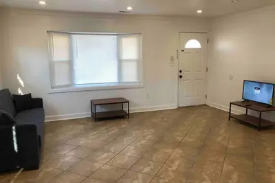an empty living room with a couch and a television at Private 2-bedroom house, free parking, 15-min walk to direct NYC Manhattan train, MetLife Stadium FIFA World Cup 30 minutes away in Edgar
