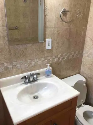 a bathroom with a sink and a toilet at Private 2-bedroom house, free parking, 15-min walk to direct NYC Manhattan train, MetLife Stadium FIFA World Cup 30 minutes away in Edgar