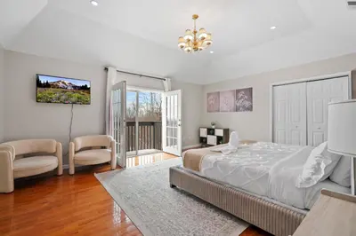 a bedroom with a large bed and a living room at Spacious 6 BR Villa - Serene Scenic Mountain Escape in Bloomingburg