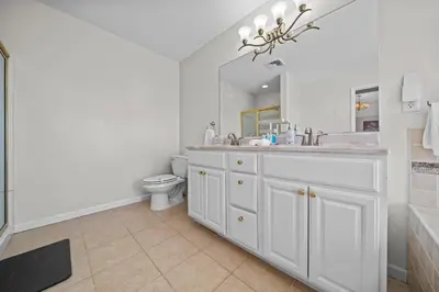 a white bathroom with a sink and a toilet at Spacious 6 BR Villa - Serene Scenic Mountain Escape in Bloomingburg