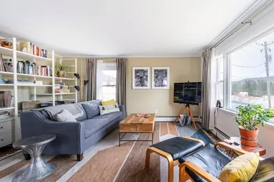 a living room with a couch and a table at Hillcrest Cottage - Charming Cottage with hot tub and view! in Obernburg