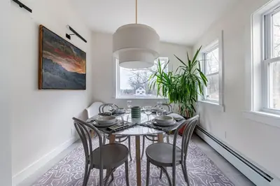a dining room with a table and chairs at Hillcrest Cottage - Charming Cottage with hot tub and view! in Obernburg