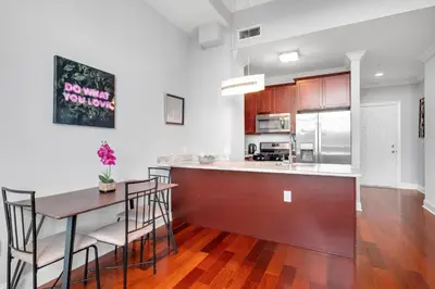 a kitchen and dining room with a table and chairs at Nice 1BR Luxury Flat - Pool & Gym in Philadelphia