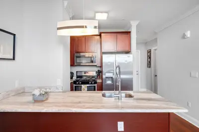 a kitchen with a sink and a refrigerator at Nice 1BR Luxury Flat - Pool & Gym in Philadelphia