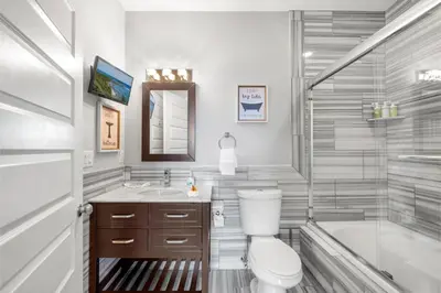 a bathroom with a toilet and a tub and a sink at Nice 1BR Luxury Flat - Pool & Gym in Philadelphia