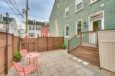 a patio with a table and chairs and a fence at Chic Lancaster Vacation Rental, Walkable Location! in Lancaster