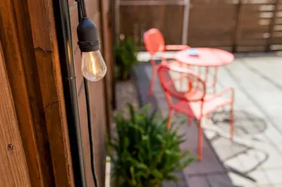 a light on a door with a table and chairs on a patio at Chic Lancaster Vacation Rental, Walkable Location! in Lancaster
