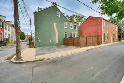 a green building on the side of a street at Chic Lancaster Vacation Rental, Walkable Location! in Lancaster
