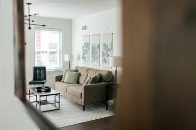a living room with a couch and a chair at Chic Lancaster Vacation Rental, Walkable Location! in Lancaster