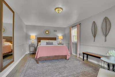 a bedroom with a bed with a pink blanket at Nature Haven Pond,Pool and Hot Tub in Myerstown