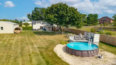 a backyard with a hot tub in the grass at Nature Haven Pond,Pool and Hot Tub in Myerstown