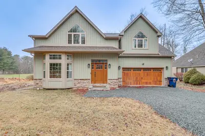 a house with orange doors and a driveway at BBQ-Ready Deck Lake Harmony Home with Fire Pit in Lake Harmony