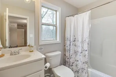 a bathroom with a sink and a toilet and a window at BBQ-Ready Deck Lake Harmony Home with Fire Pit in Lake Harmony