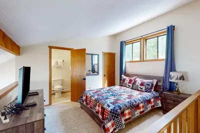 a bedroom with a bed and a flat screen tv at Mountain Home at Camelback in Tannersville
