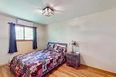a bedroom with a bed and a window at Mountain Home at Camelback in Tannersville